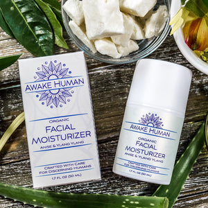 Awake Human Organic Facial Moisturizer anise and ylang ylang with shea butter aloe vera and oils on table